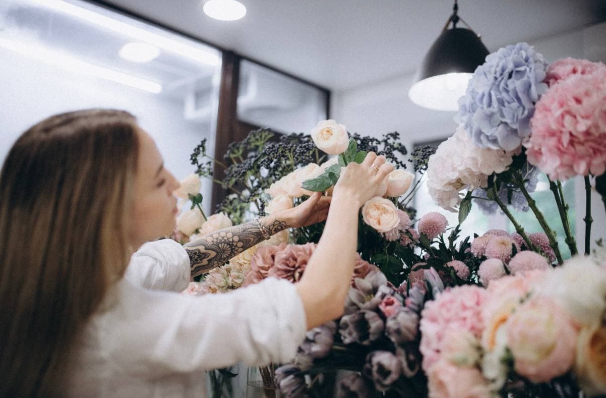 Alina arranging flowers at the NewSense studio
